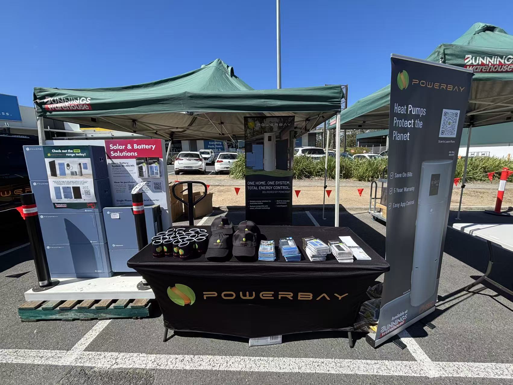 PowerBay stand with battery and inverter displays, heat pump banners and brochures at the Bunnings Croydon Trade Event.